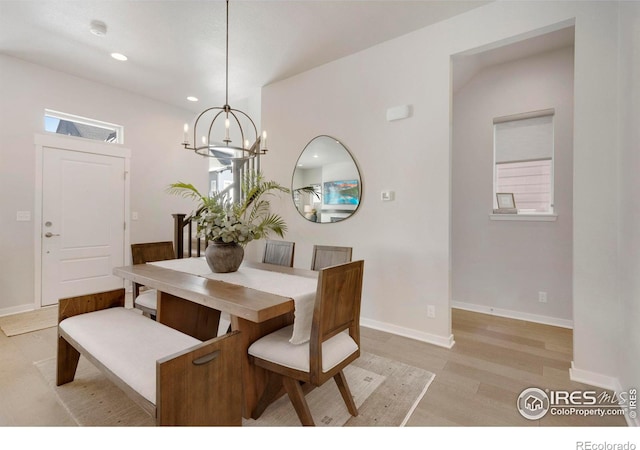 dining area with a chandelier, light wood-type flooring, recessed lighting, and baseboards