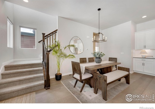 dining room with stairs, baseboards, a chandelier, and recessed lighting