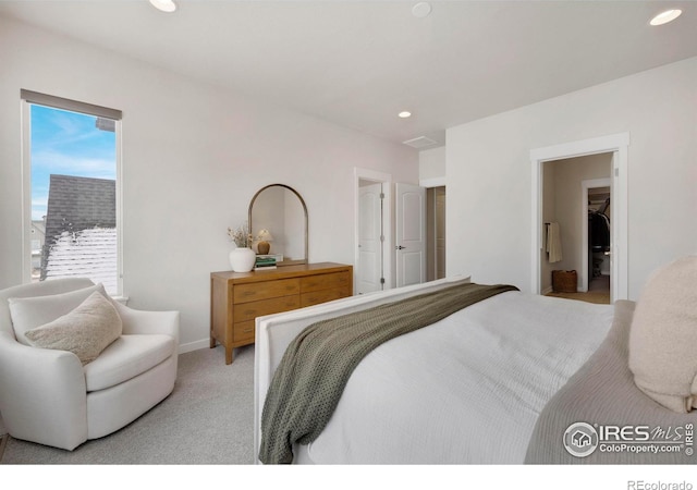 bedroom featuring recessed lighting, light colored carpet, and a spacious closet