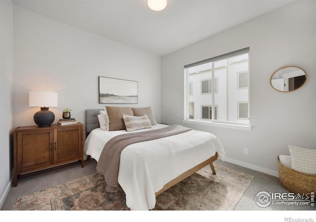 carpeted bedroom featuring baseboards