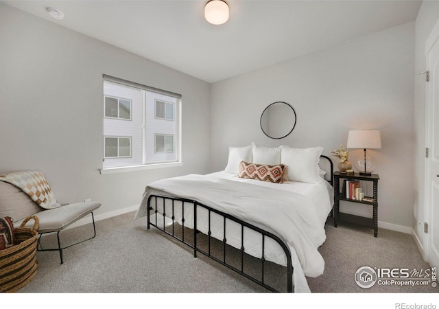 bedroom featuring carpet flooring and baseboards