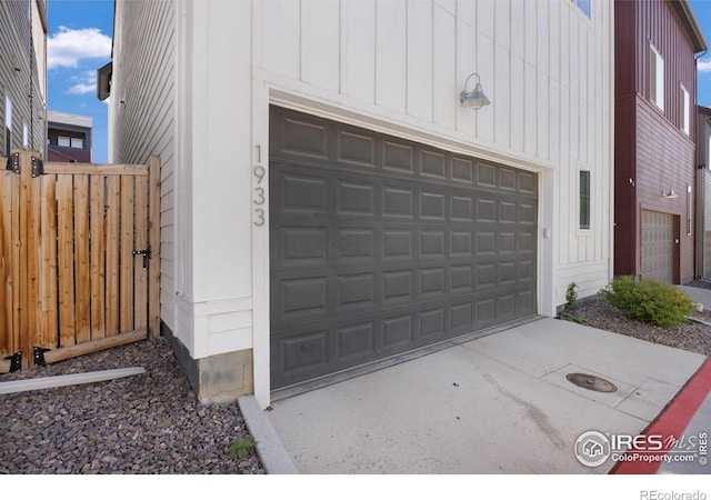 garage featuring fence and driveway
