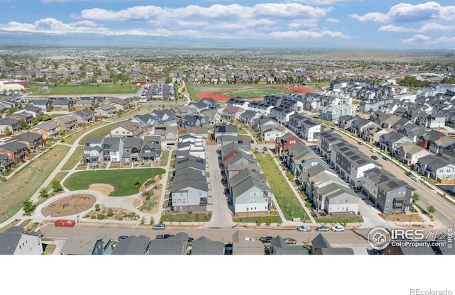 aerial view of property and surrounding area featuring nearby suburban area
