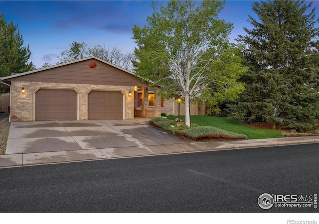 4880 Filbert Dr, Loveland, CO 80538 - single story home featuring brick siding, an attached garage, a yard, and driveway