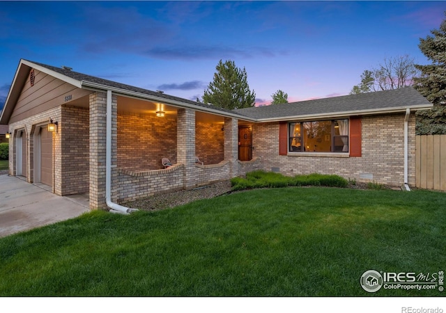 4880 Filbert Dr, Loveland, CO 80538 - ranch-style house with an attached garage, driveway, a front yard, and brick siding