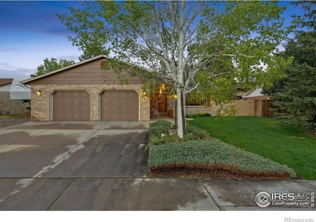 4880 Filbert Dr, Loveland, CO 80538 - single story home featuring brick siding, an attached garage, and driveway