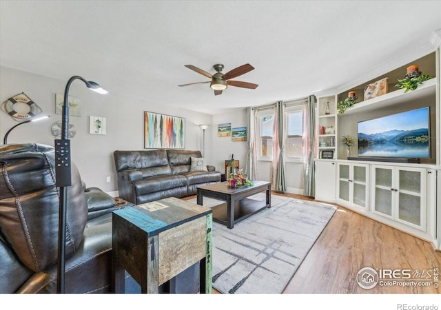 4880 Filbert Dr, Loveland, CO 80538 - living area with ceiling fan, wood finished floors, and built in shelves