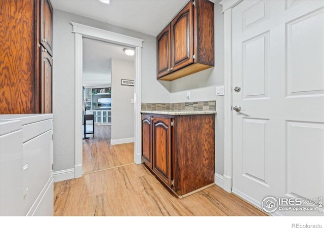 4880 Filbert Dr, Loveland, CO 80538 - laundry room featuring light wood finished floors and baseboards
