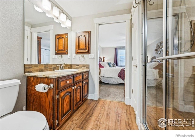 4880 Filbert Dr, Loveland, CO 80538 - full bathroom with toilet, wood finished floors, a stall shower, and vanity