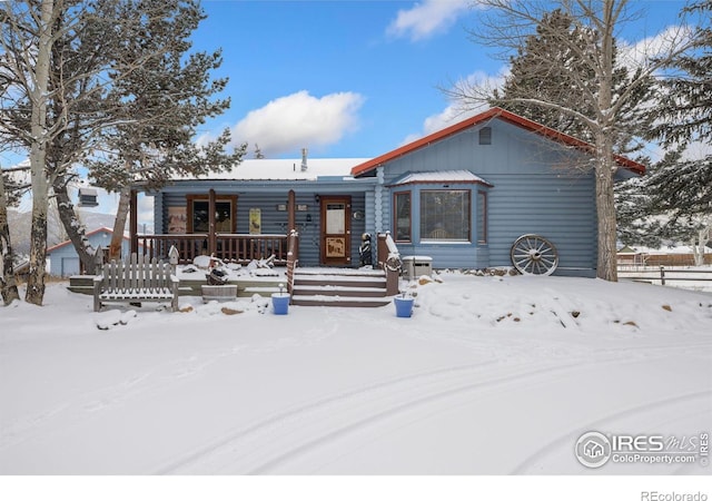 1810 N Ridge Ln, Estes Park, CO 80517 - snow covered property featuring covered porch and fence