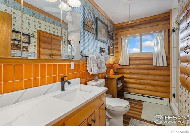 1810 N Ridge Ln, Estes Park, CO 80517 - bathroom featuring baseboard heating, log walls, toilet, vanity, and wood finished floors