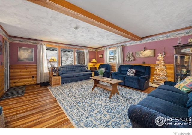1810 N Ridge Ln, Estes Park, CO 80517 - living room featuring hardwood / wood-style flooring, beam ceiling, a textured ceiling, rustic walls, and a baseboard radiator