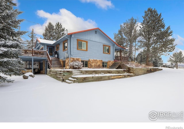 1810 N Ridge Ln, Estes Park, CO 80517 - view of snowy exterior with stairway and a wooden deck