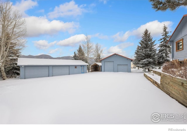 1810 N Ridge Ln, Estes Park, CO 80517 - snowy yard with a garage and an outdoor structure