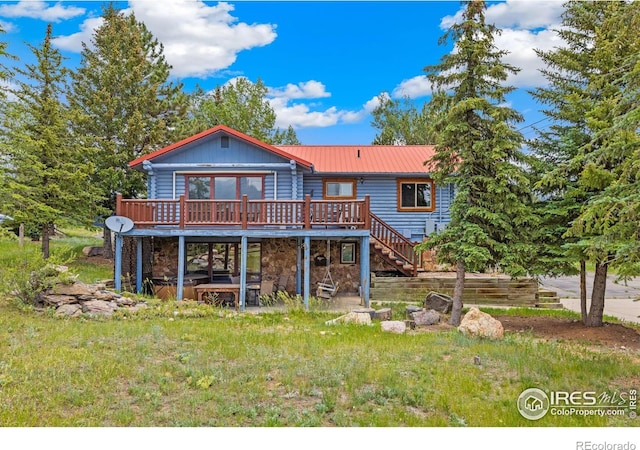 1810 N Ridge Ln, Estes Park, CO 80517 - back of house featuring a deck, stone siding, stairway, and a metal roof