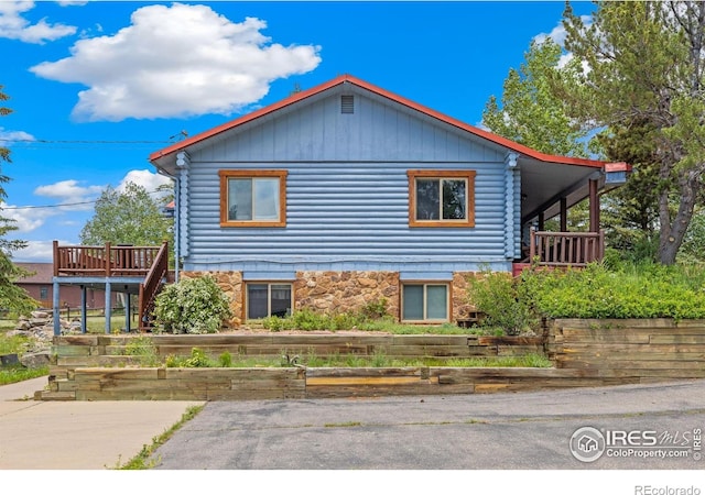 1810 N Ridge Ln, Estes Park, CO 80517 - view of side of property with log siding, a vegetable garden, and stone siding