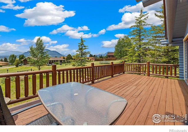 1810 N Ridge Ln, Estes Park, CO 80517 - wooden deck featuring a lawn and outdoor dining area