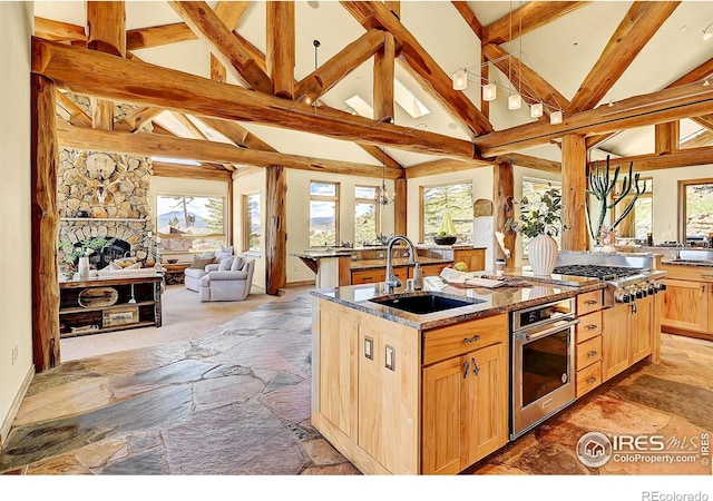 6553 Sunshine Canyon Dr, Boulder, CO 80302 - kitchen with a sink, appliances with stainless steel finishes, open floor plan, plenty of natural light, and beamed ceiling