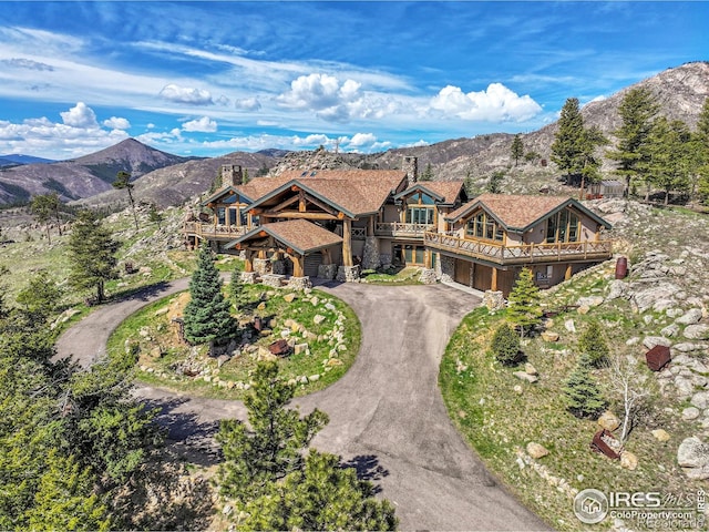 6553 Sunshine Canyon Dr, Boulder, CO 80302 - view of front of house with curved driveway, a balcony, a garage, and a mountain view