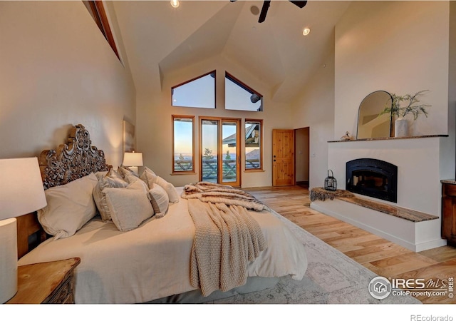 6553 Sunshine Canyon Dr, Boulder, CO 80302 - bedroom featuring wood finished floors, a glass covered fireplace, access to outside, and high vaulted ceiling