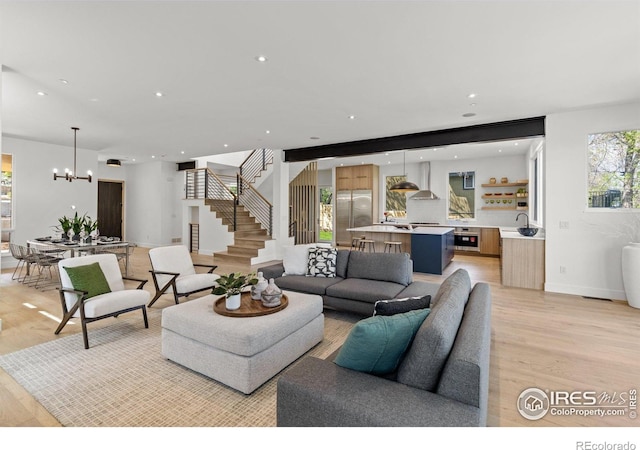 2814 3rd St, Boulder, CO 80304 - living room with a chandelier, light wood-style floors, stairway, recessed lighting, and baseboards