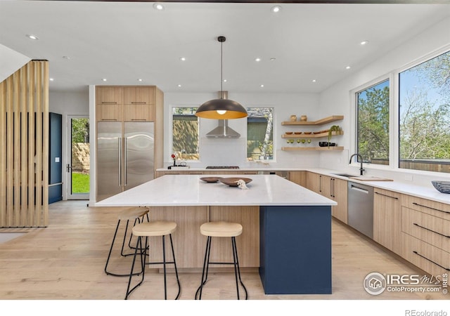 2814 3rd St, Boulder, CO 80304 - kitchen featuring modern cabinets, stainless steel appliances, light brown cabinets, a breakfast bar, and recessed lighting