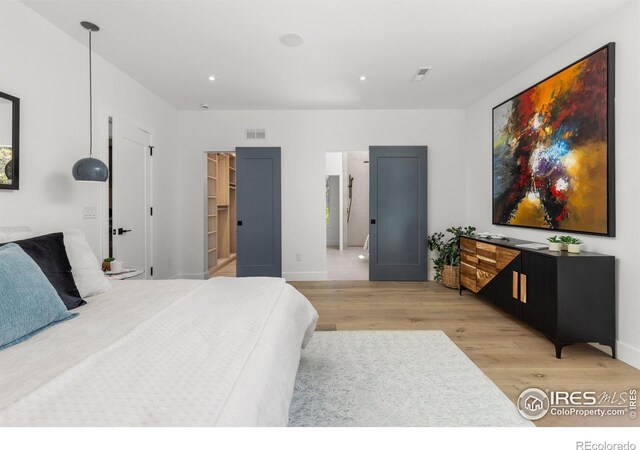 2814 3rd St, Boulder, CO 80304 - bedroom with light wood-type flooring, recessed lighting, baseboards, and a spacious closet