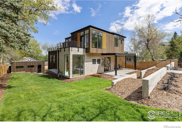 2814 3rd St, Boulder, CO 80304 - rear view of house featuring a balcony, a patio, stone siding, and an outbuilding