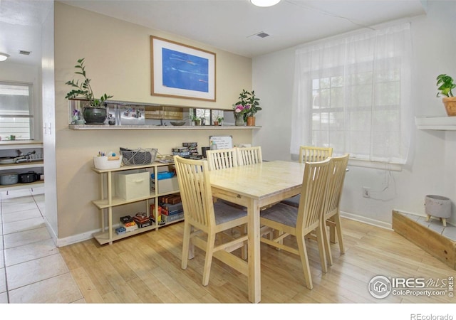 dining room with wood finished floors and baseboards