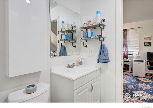 bathroom featuring vanity and toilet