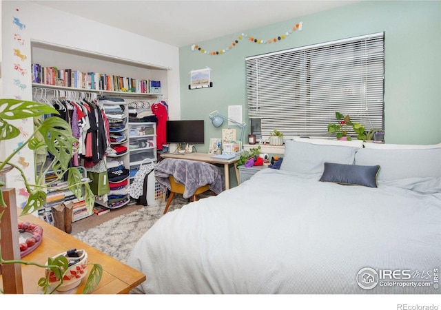 carpeted bedroom with a closet