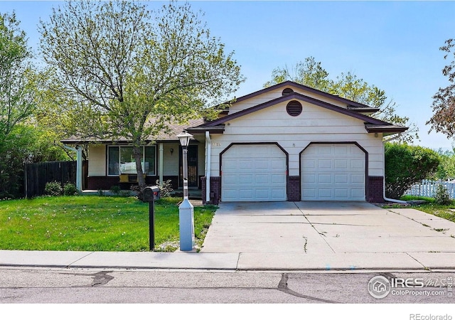 view of front of house featuring brick siding, driveway, and a garage