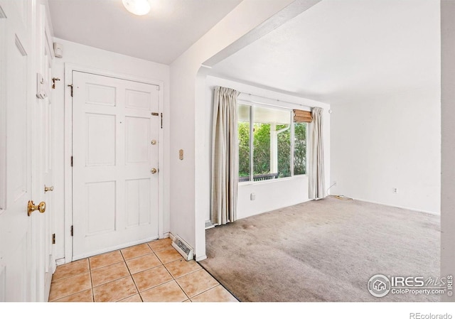 entryway featuring light carpet and light tile patterned floors