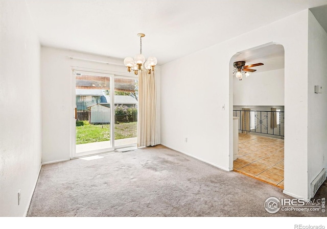 empty room featuring carpet floors, ceiling fan, a chandelier, and baseboards