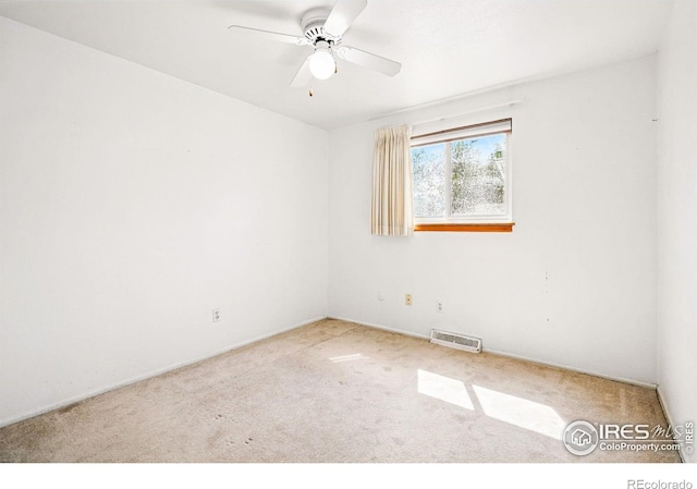 carpeted spare room featuring ceiling fan