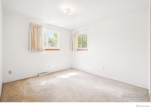 empty room with carpet floors and baseboards