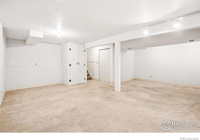 finished below grade area with carpet flooring, stairs, and baseboards