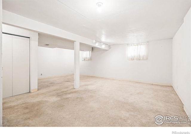 basement featuring carpet and baseboards