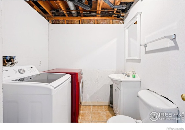 clothes washing area featuring washing machine and clothes dryer and light tile patterned flooring