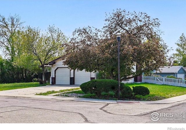 view of property hidden behind natural elements with concrete driveway and an attached garage