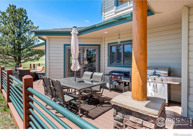 wooden deck featuring outdoor dining space and grilling area
