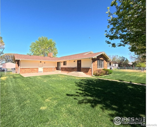 718 Linda St, Fort Morgan, CO 80701 - view of front facade featuring brick siding and a chimney