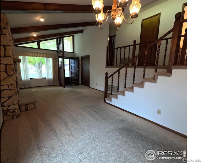 718 Linda St, Fort Morgan, CO 80701 - foyer entrance featuring a chandelier, carpet flooring, stairway, and baseboards