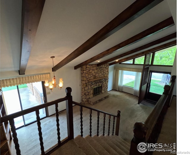 718 Linda St, Fort Morgan, CO 80701 - staircase with carpet floors, a chandelier, beam ceiling, and a fireplace