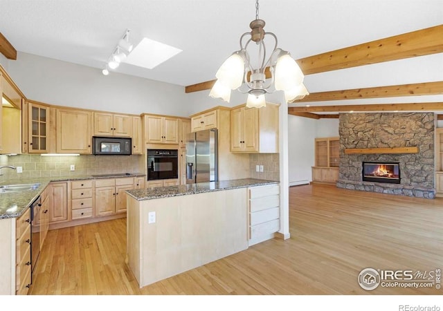 272 Solomon Dr, Estes Park, CO 80517 - kitchen featuring black appliances, light brown cabinets, a sink, light wood-style floors, and a skylight