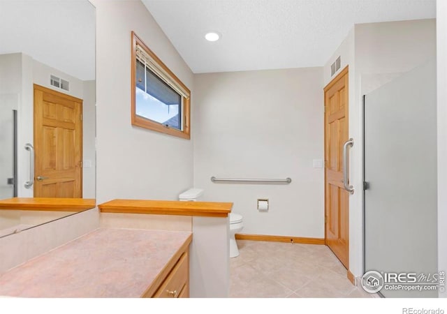272 Solomon Dr, Estes Park, CO 80517 - bathroom featuring toilet, vanity, baseboards, tile patterned flooring, and recessed lighting