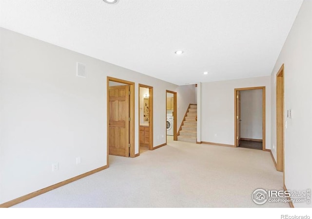 272 Solomon Dr, Estes Park, CO 80517 - carpeted spare room featuring washer / dryer, baseboards, stairway, and recessed lighting