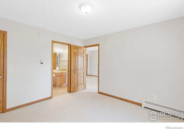 272 Solomon Dr, Estes Park, CO 80517 - unfurnished bedroom featuring a baseboard radiator, baseboards, light colored carpet, and ensuite bathroom