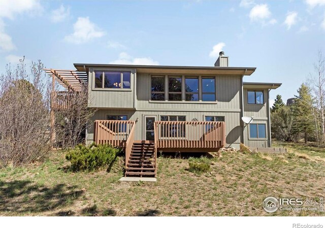 272 Solomon Dr, Estes Park, CO 80517 - back of property featuring stairs, a deck, and a chimney