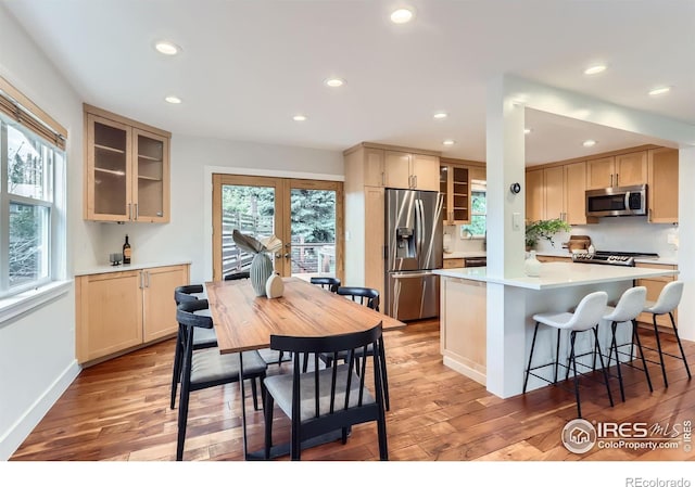 2550 Woodstock Pl, Boulder, CO 80305 - kitchen featuring appliances with stainless steel finishes, light wood-style flooring, recessed lighting, glass insert cabinets, and light countertops